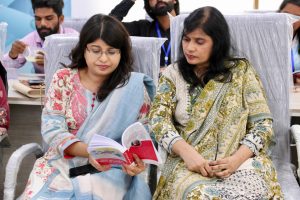 Two women look at the training manual